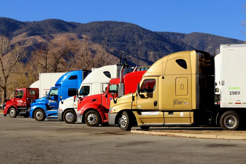 Line of freight tractor units at a truck stop